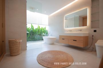 Modern bathroom with double vanity and freestanding bathtub