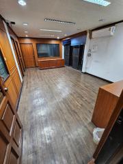 Spacious interior of a property showing wooden flooring and cabinetry