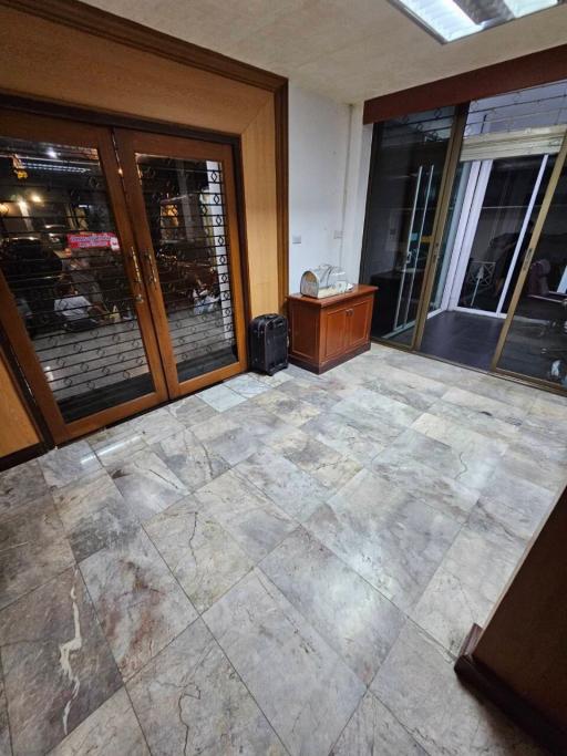 Spacious room with marble flooring and wooden frames