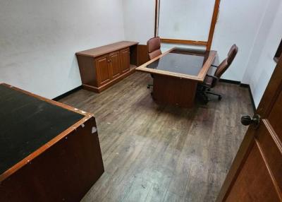 Spacious office with wooden furniture and hardwood flooring