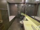 Modern bathroom with glass shower cubicle, tiled walls, and integrated lighting