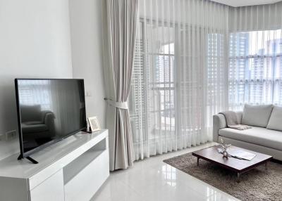 Modern living room with large windows and natural lighting