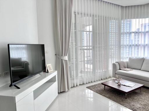 Modern living room with large windows and natural lighting