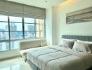 Modern bedroom with large window overlooking the city