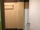 Compact bathroom with tiled walls and shower area