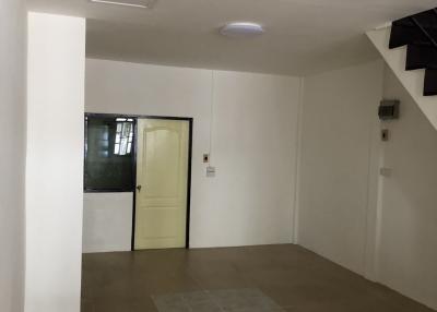 Spacious and bright empty room with tiled floor and white walls