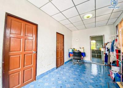 Bright and spacious room with blue tiled flooring and multiple doors