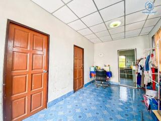 Bright and spacious room with blue tiled flooring and multiple doors