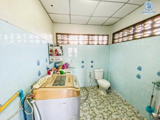 Compact bathroom with washing machine and blue tile walls