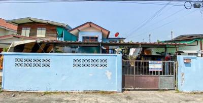 Exterior view of a residential building with blue gate