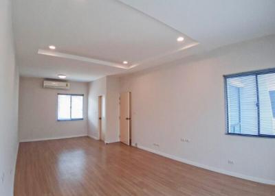 Spacious and well-lit empty room with hardwood floors