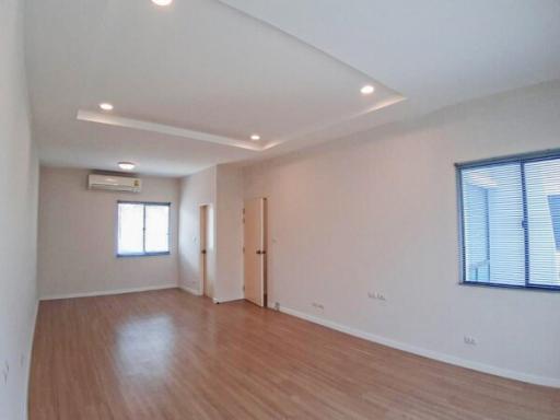 Spacious and well-lit empty room with hardwood floors