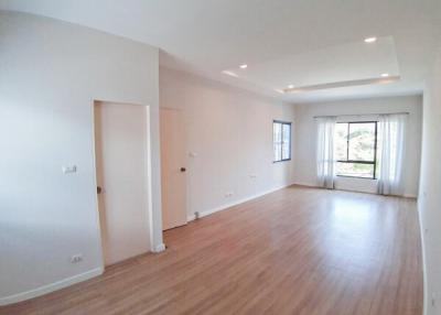 Spacious and bright empty living room with hardwood floors and large windows