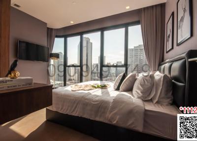 Modern bedroom with large windows and city view