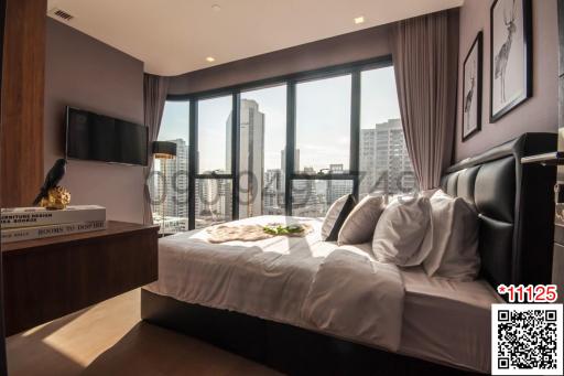 Modern bedroom with large windows and city view