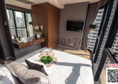 Modern bedroom with large bed and city view