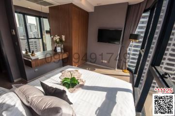 Modern bedroom with large bed and city view