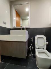 Modern bathroom with a wall-mounted sink and toilet