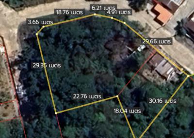 Aerial view of a property with demarcated boundaries and surrounding area