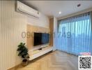 Bright and modern living room with mounted TV and air conditioning