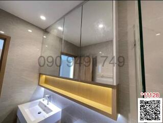 Modern bathroom with large mirror and under-sink lighting