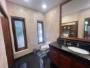 Spacious bathroom with marble finishing and modern fixtures