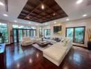 Spacious and elegant living room with hardwood floors and high ceiling
