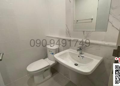 White modern bathroom with ceramic fixtures