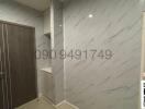 Modern entryway with marble wall tiles and wooden door