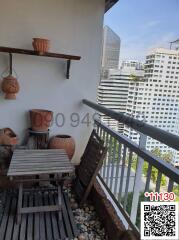 Cozy balcony with wooden furniture and city view