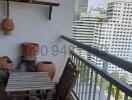 Cozy balcony with wooden furniture and city view