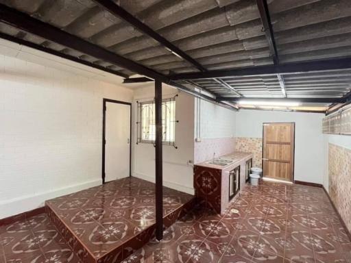 Spacious kitchen with tile flooring and exposed ceiling beams