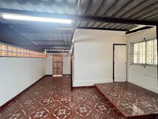 Empty room with patterned tile flooring and natural light