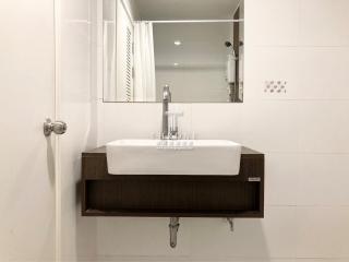 Modern bathroom sink with wall-mounted wooden vanity