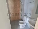 Compact bathroom interior with toilet and bidet