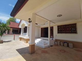 Spacious and sunny front patio of a residential house with clear blue sky