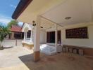 Spacious and sunny front patio of a residential house with clear blue sky