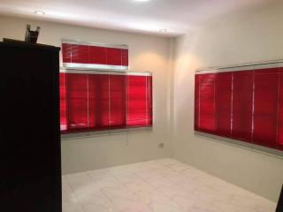 Minimalist bedroom with large windows and red blinds