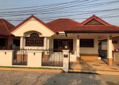Front view of a residential house with red tiled roof and gated entrance