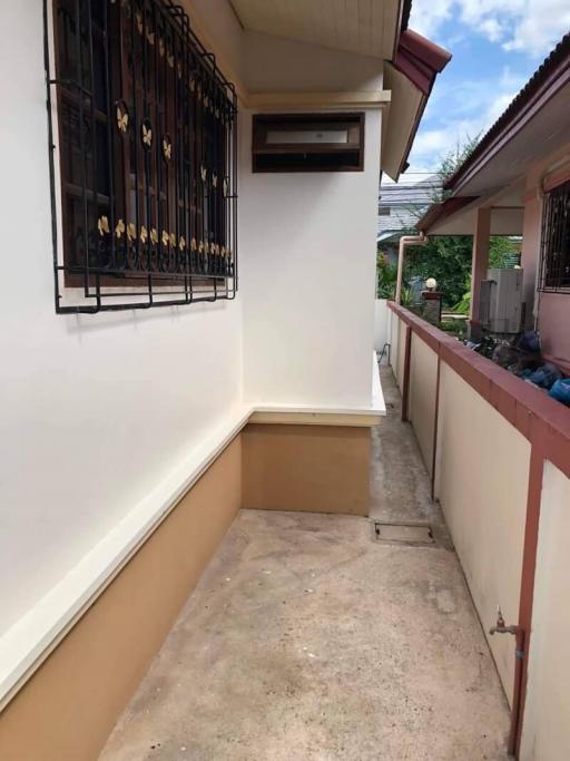 Side alley of a residential house with security window bars