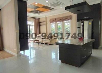 Spacious modern living room with kitchen island and large windows