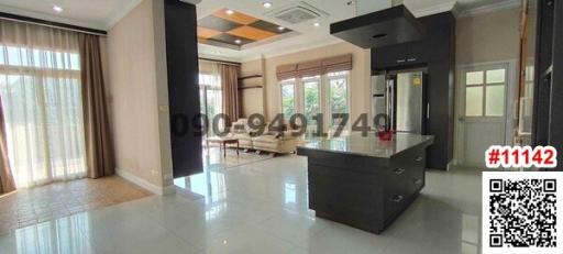 Spacious modern living room with kitchen island and large windows