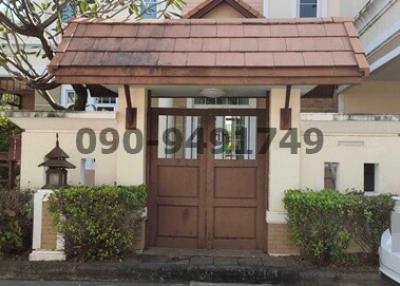 Elegant residential entrance with wooden gate and tiled roof