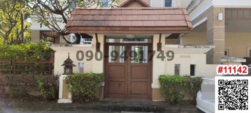 Elegant residential entrance with wooden gate and tiled roof