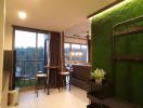Modern living room with natural light and green wall feature
