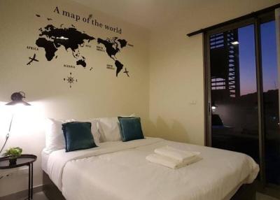 Cozy bedroom interior with world map wall decor and evening view