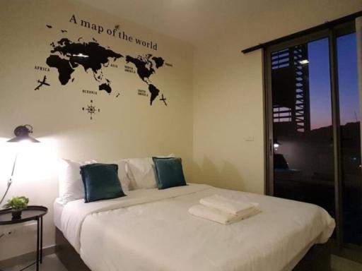 Cozy bedroom interior with world map wall decor and evening view