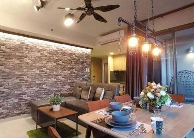 Modern living room with dining area and stone accent wall