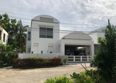 Modern two-story house with a spacious garage and landscaped front yard