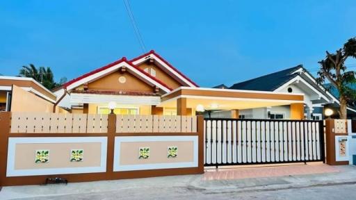 Modern single-family home with a gated entrance during twilight